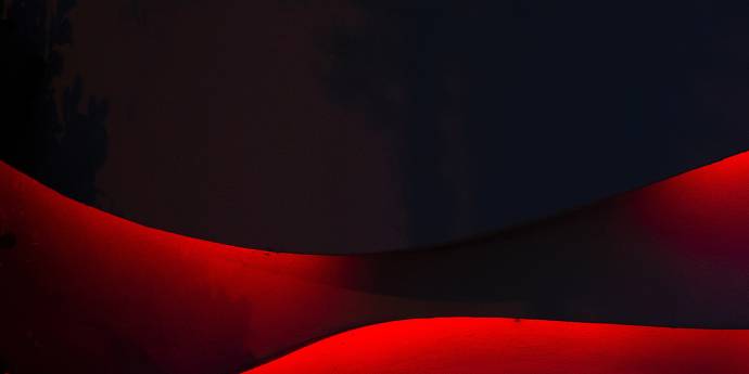 Red shapes against a black background