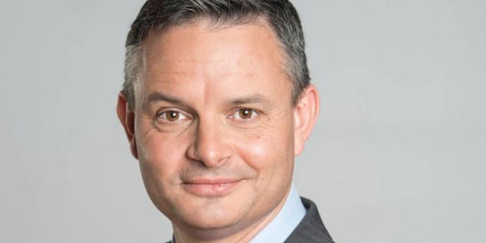 A headshot of James Shaw grinning. 