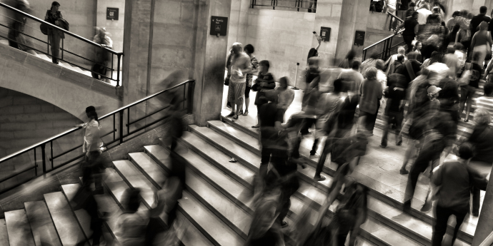 blurred people walking up and down stairs