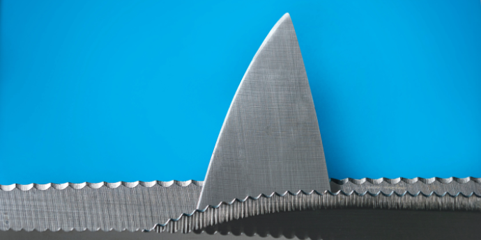 Shark fin in a sea made of chainsaw teeth with blue background